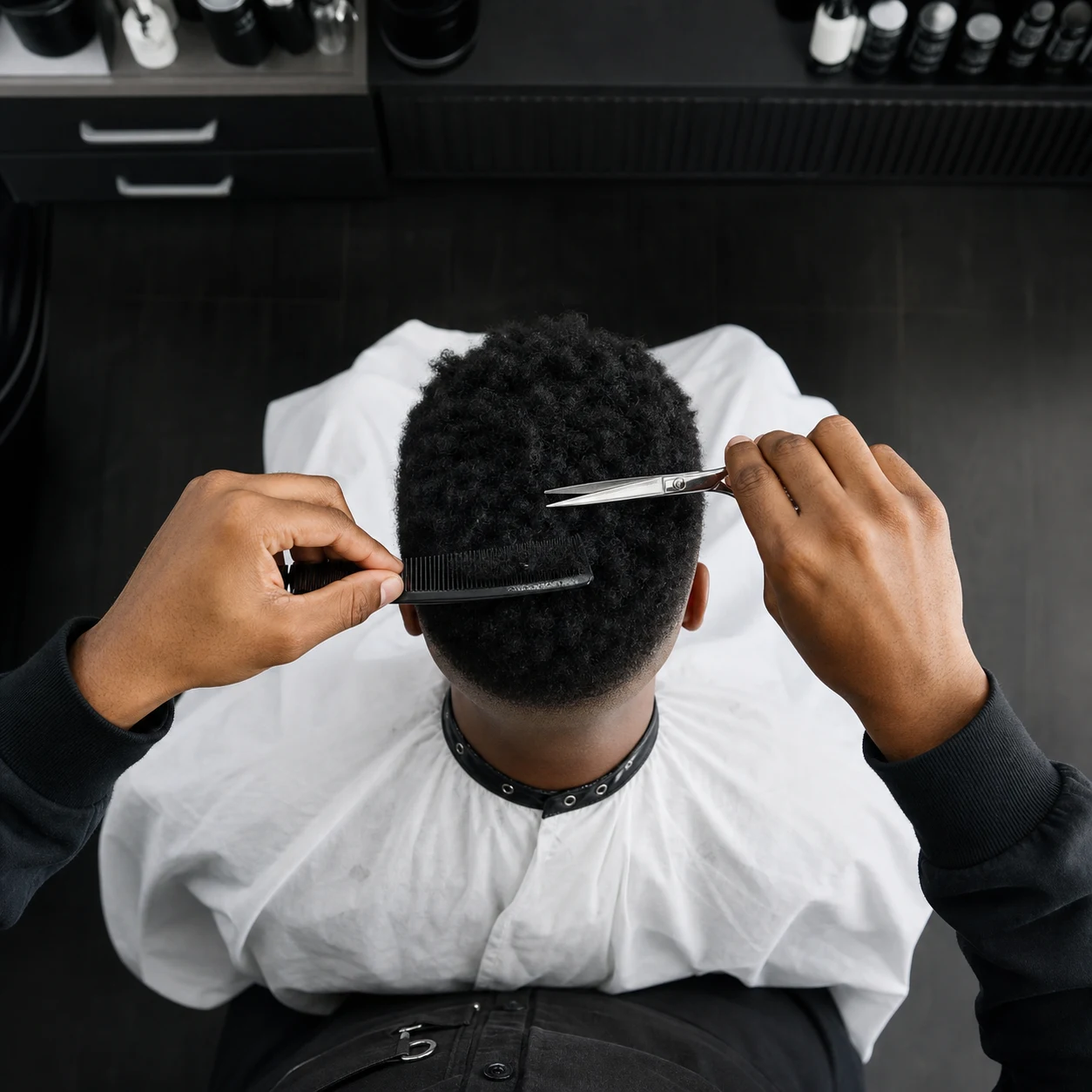 Barber cutting a client's hair from above